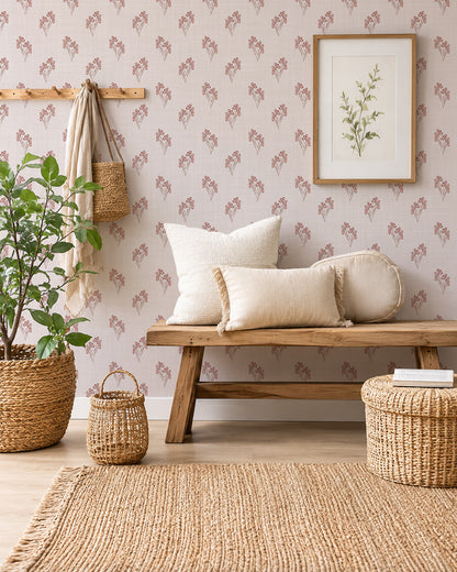 Foraged Bloom Blush wallpaper in a cozy room with a wood bench, cream cushions and woven baskets.