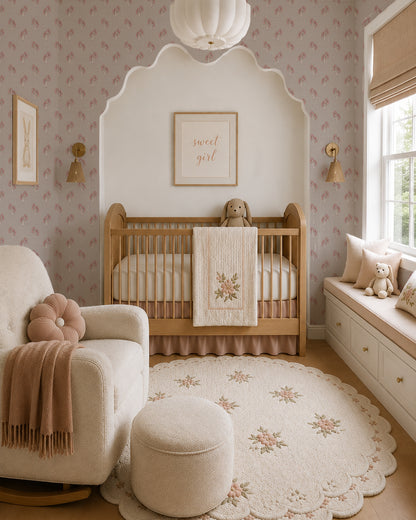 Foraged Bloom Warm Brown wallpaper in a cozy nursery with a wood crib, cream chair and soft blush accents.
